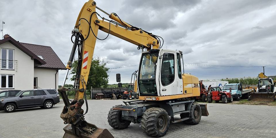 Koparka kołowa Liebherr A314 Litronic 9350 h 4 łyżki kołówka - Excavadora de ruedas: foto 2 Koparka kołowa Liebherr A314 Litronic 9350 h 4 łyżki kołówka - Excavadora de ruedas: foto 2