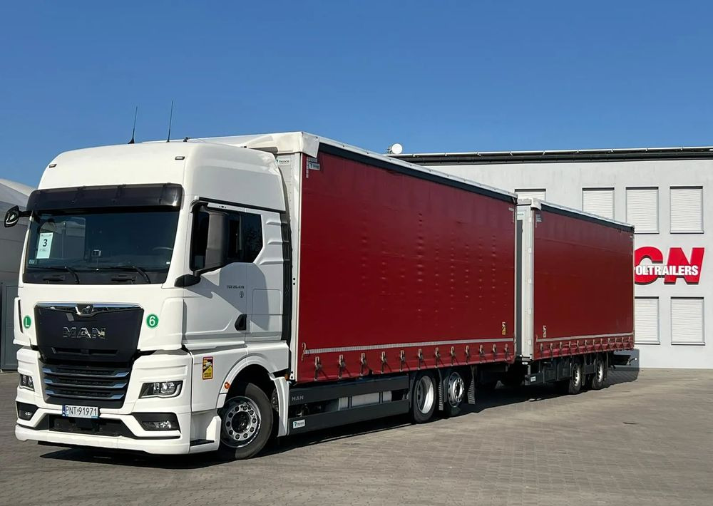 MAN TGX 26.470 z przyczepą Redos - Camión lona: foto 1 MAN TGX 26.470 z przyczepą Redos - Camión lona: foto 1